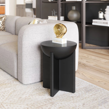 Black side table with a decorative object in a living room setting