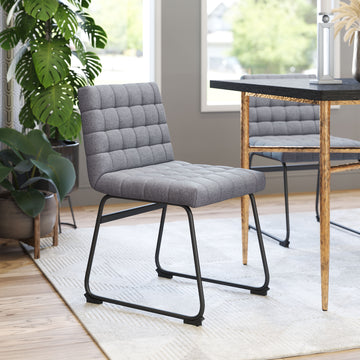 earth-toned fabric accent chair in a minimalist dining room setting