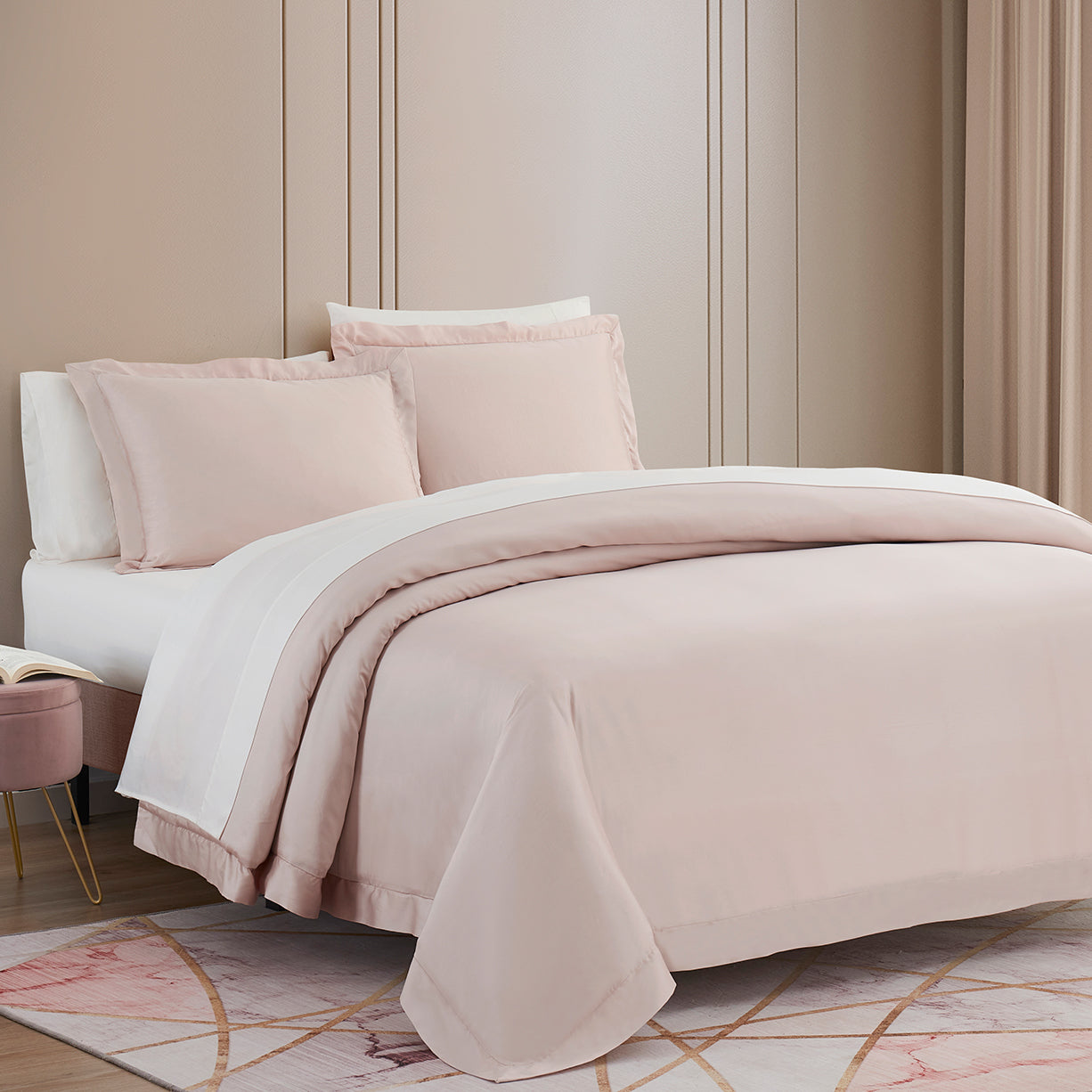 Neatly made bed with pink bedding in a bedroom setting