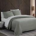 Gray bedding set on a bed with a wooden headboard in a bedroom setting.