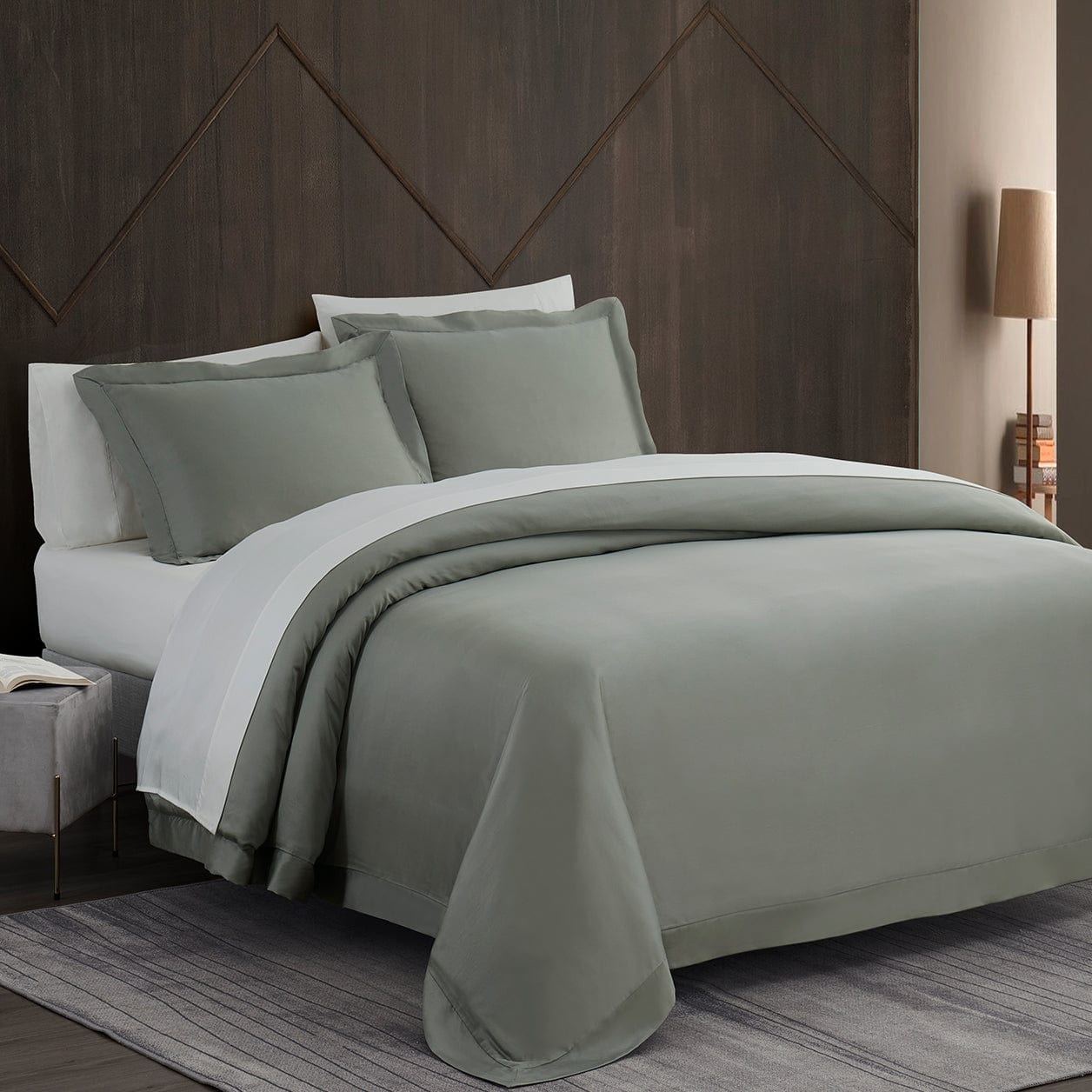 Gray bedding set on a bed with a wooden headboard in a bedroom setting.
