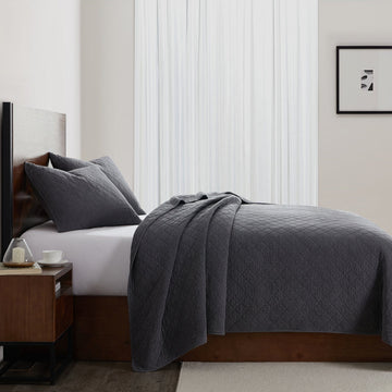 earth-toned textured quilt in a classic contemporary bedroom setting