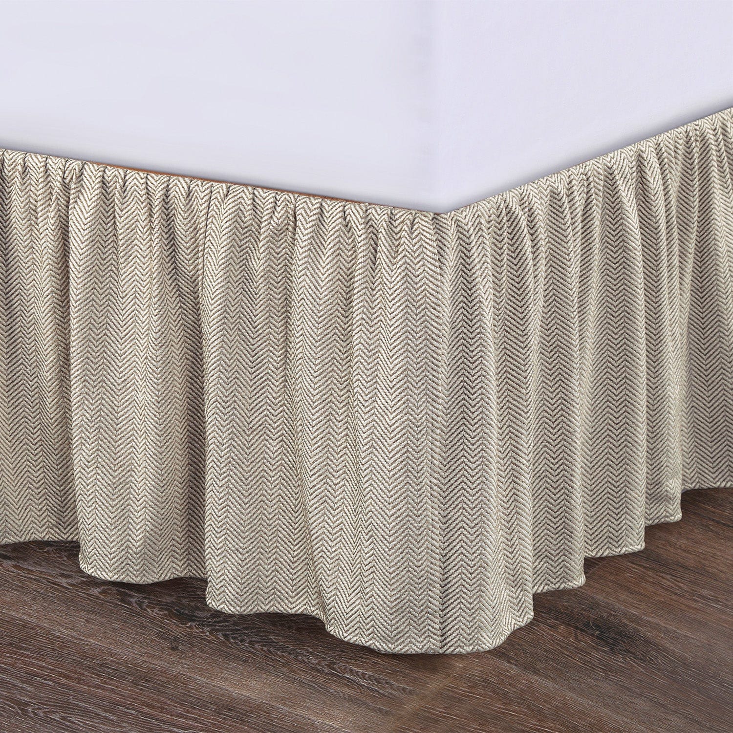 earth-toned textured bed skirt in a minimalist guest room setting