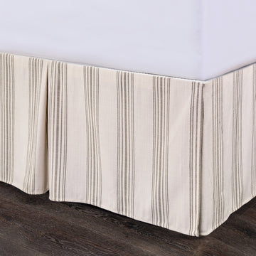 earth-toned textured bed skirt in a modern bedroom setting
