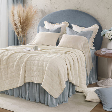 earth-toned textured quilt in a minimalist guest room setting