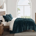 gray cotton quilt in a minimalist guest room setting