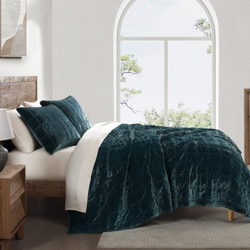 gray cotton quilt in a minimalist guest room setting