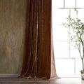 Brown velvet curtain in a room with a window and plant