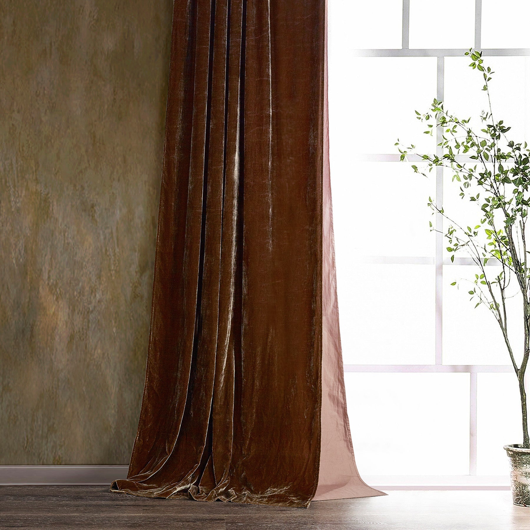 Brown velvet curtain in a room with a window and plant