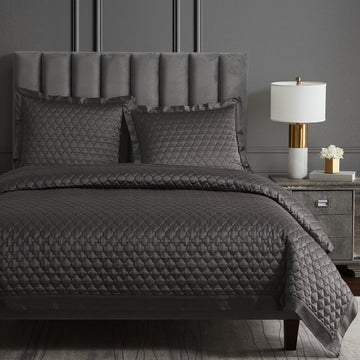 gray cotton quilt in a contemporary master bedroom setting