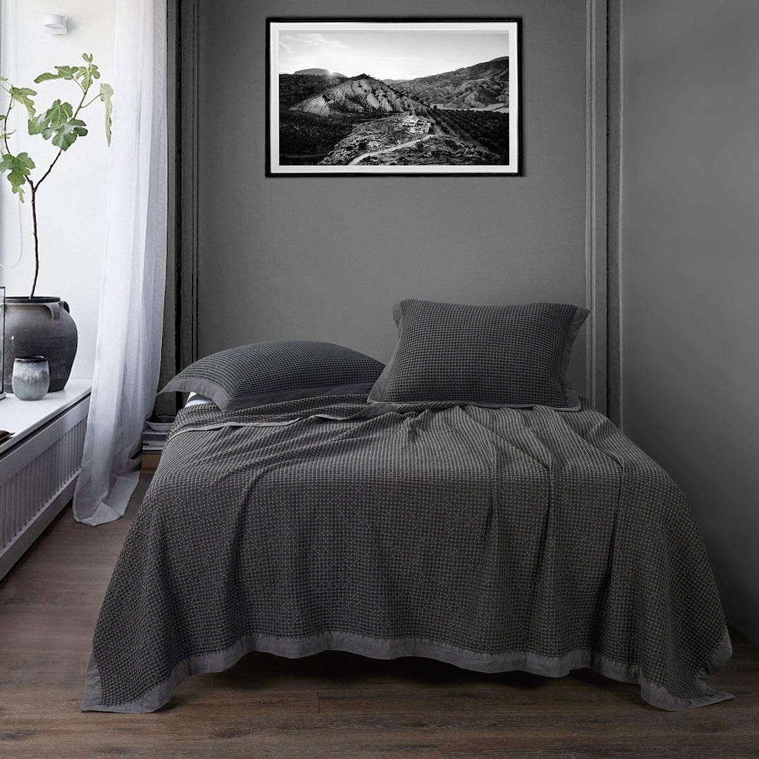 gray canvas home décor piece in a modern bedroom setting