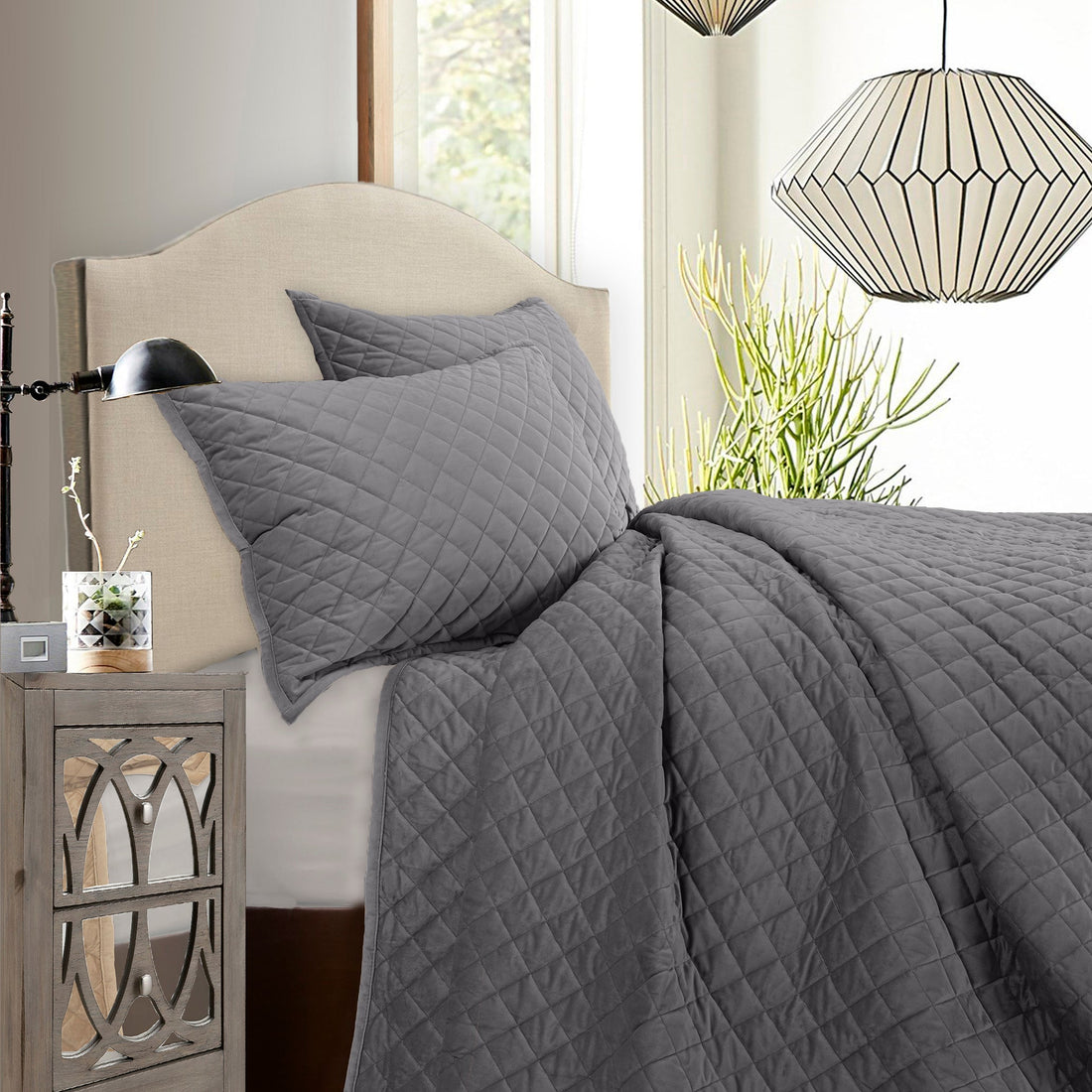 earth-toned fabric quilt in a refined master bedroom setting