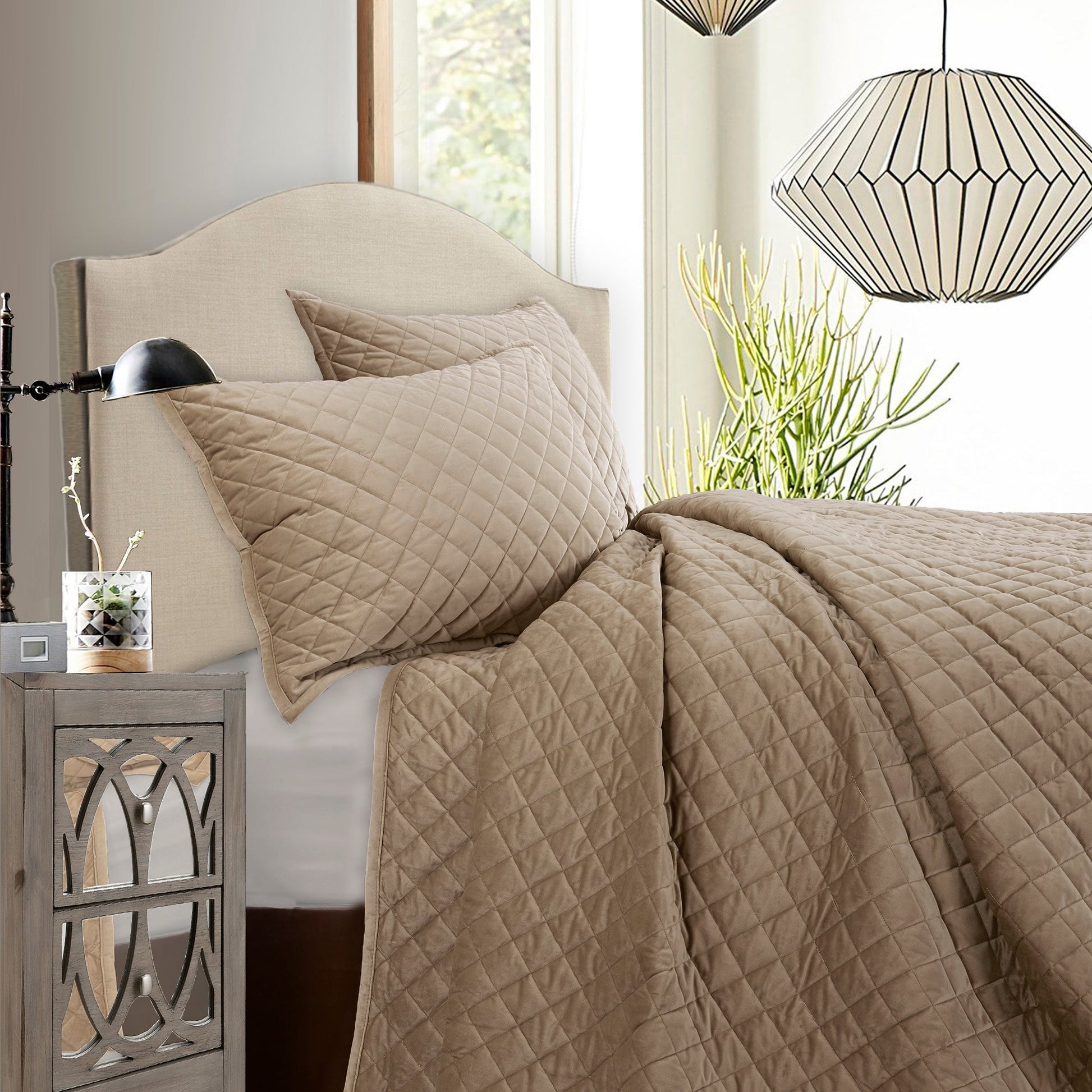 earth-toned fabric quilt in a refined master bedroom setting