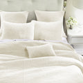 neutral-toned linen quilt in a elegant modern bedroom setting