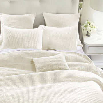 neutral-toned linen quilt in a elegant modern bedroom setting