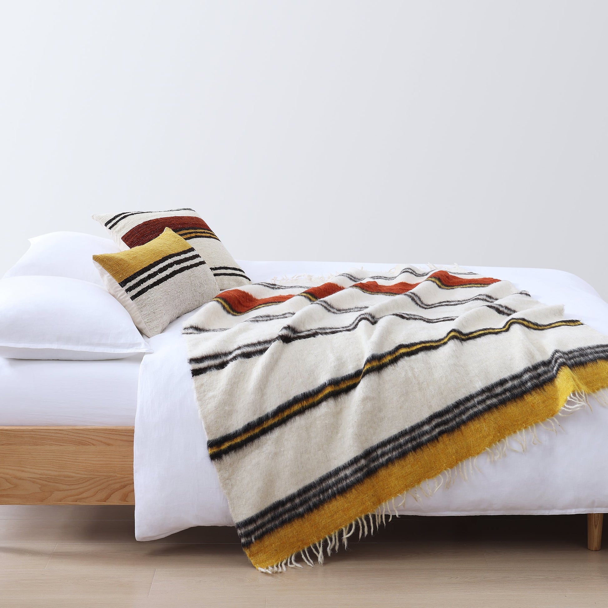 warm-toned soft decorative pillow in a refined master bedroom setting