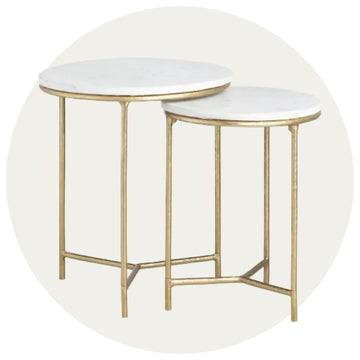 Set of two nesting tables with marble tops and gold metal frames on a white background