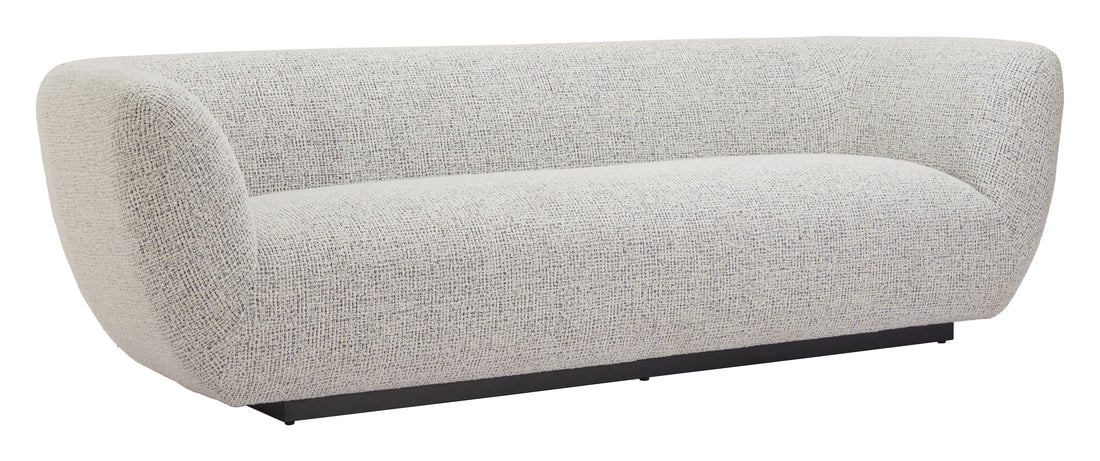 earth-toned marble sofa styled in a transitional serene master suite