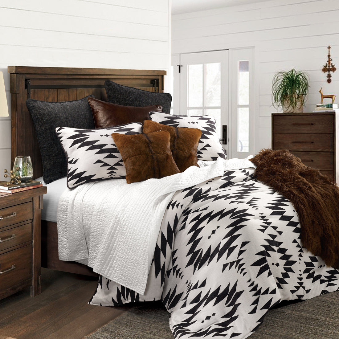 cream brushed metal comforter set styled in a contemporary minimalist entryway