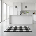 Modern kitchen with a black and white checkered rug on the floor.
