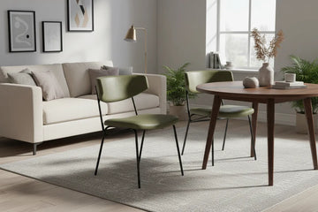 Modern living room with a sofa, charon dining chairs pair, and a dining table.