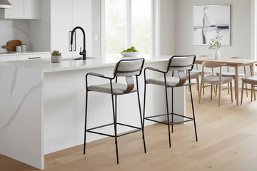 Modern kitchen with white island, 2 couva bar stools, and a dining area.