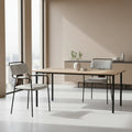 Dining area with a wooden table and 2 couva dining gray chairs in a modern interior setting.