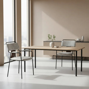 Dining area with a wooden table and 2 couva dining gray chairs in a modern interior setting.