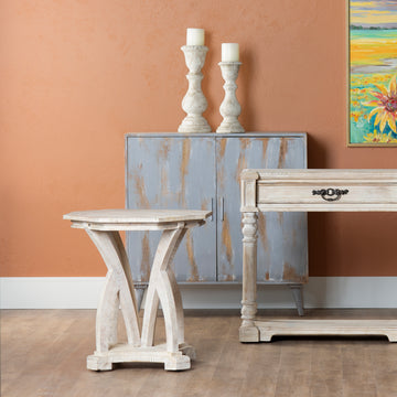 white brushed accent table in a contemporary cozy bedroom setting