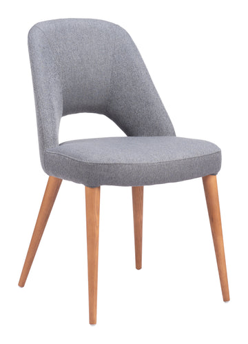 neutral linen accent chair styled in a coastal elegant dining room