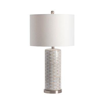 earth-toned fabric table lamp in a coastal guest room setting