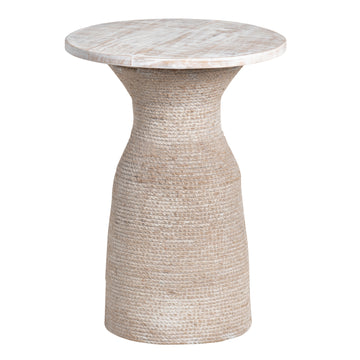 cream woven accent table in a minimalist dining room setting