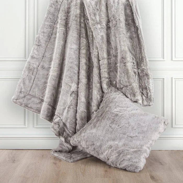 warm-toned brushed metal pillow sham styled in a contemporary minimalist entryway
