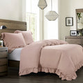 Bedroom with pink bedding and wooden furniture