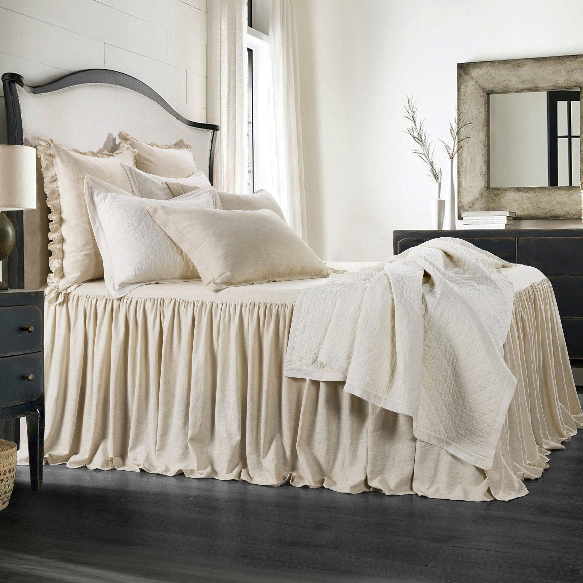 Neatly made bed with beige bedding in a bedroom setting.