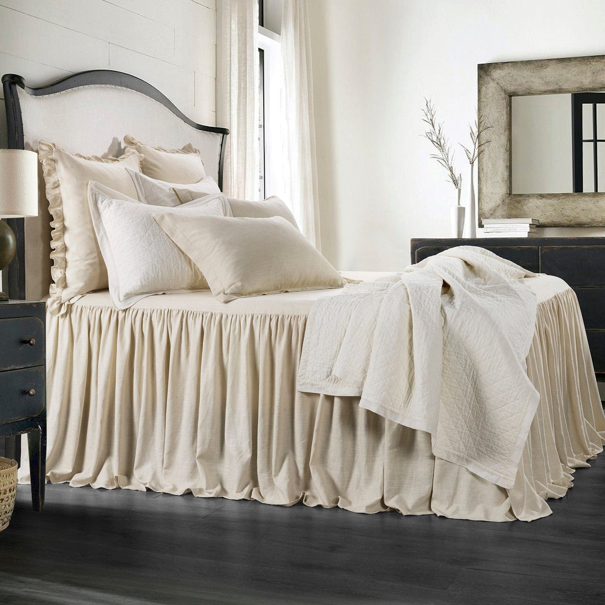 Neatly made bed with beige bedding in a bedroom setting.