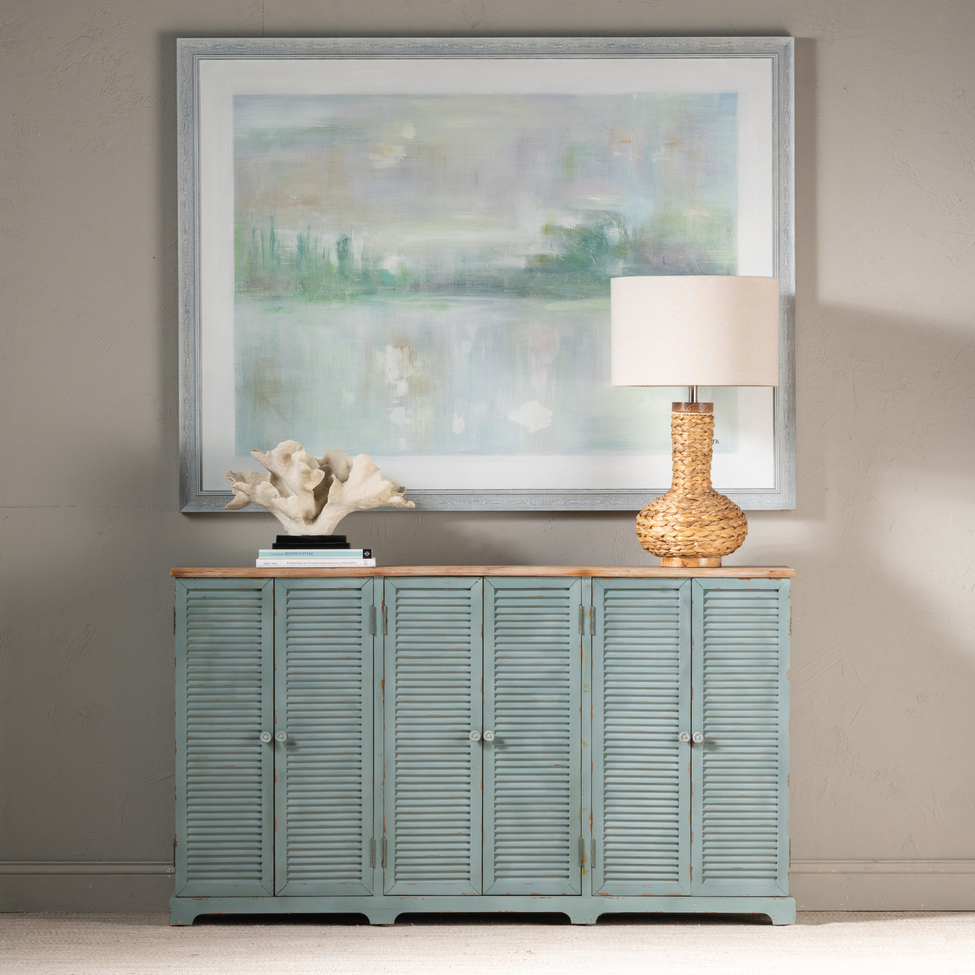 white brushed accent table in a farmhouse contemporary bedroom setting
