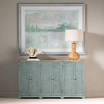 white brushed accent table in a farmhouse contemporary bedroom setting
