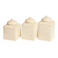 Set of three cream-colored ceramic canisters with textured lids on a white background