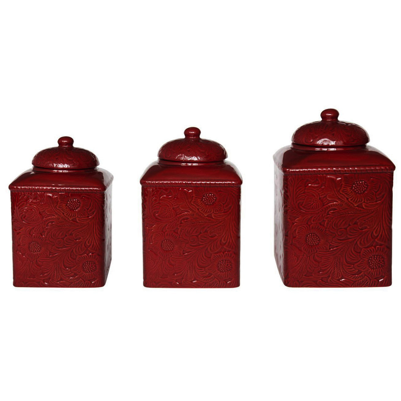 Set of three red ceramic canisters with embossed designs on a white background