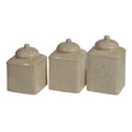 Set of three beige ceramic canisters with decorative patterns on a white background