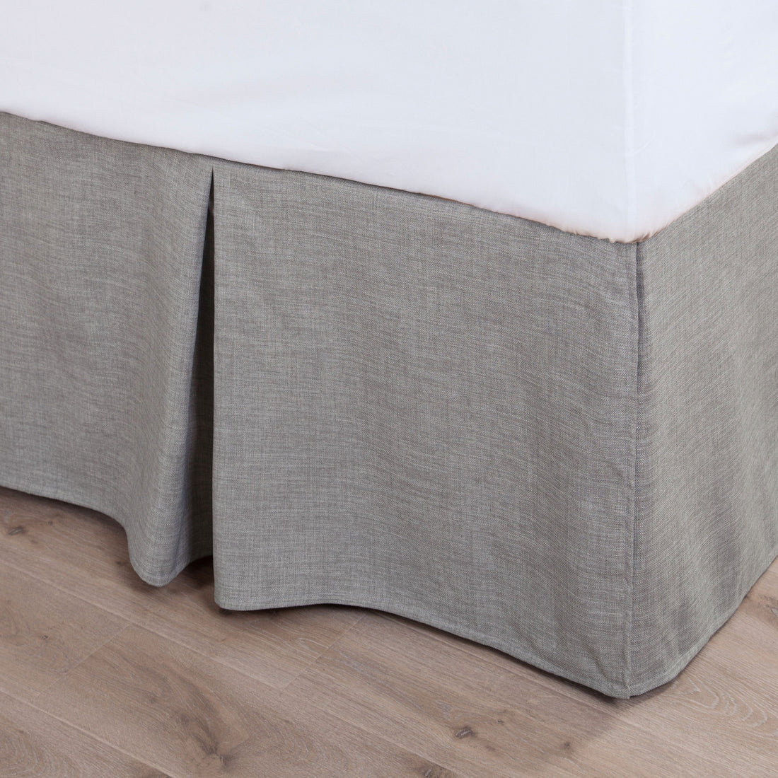 warm-toned brushed metal bed frame styled in a contemporary minimalist entryway